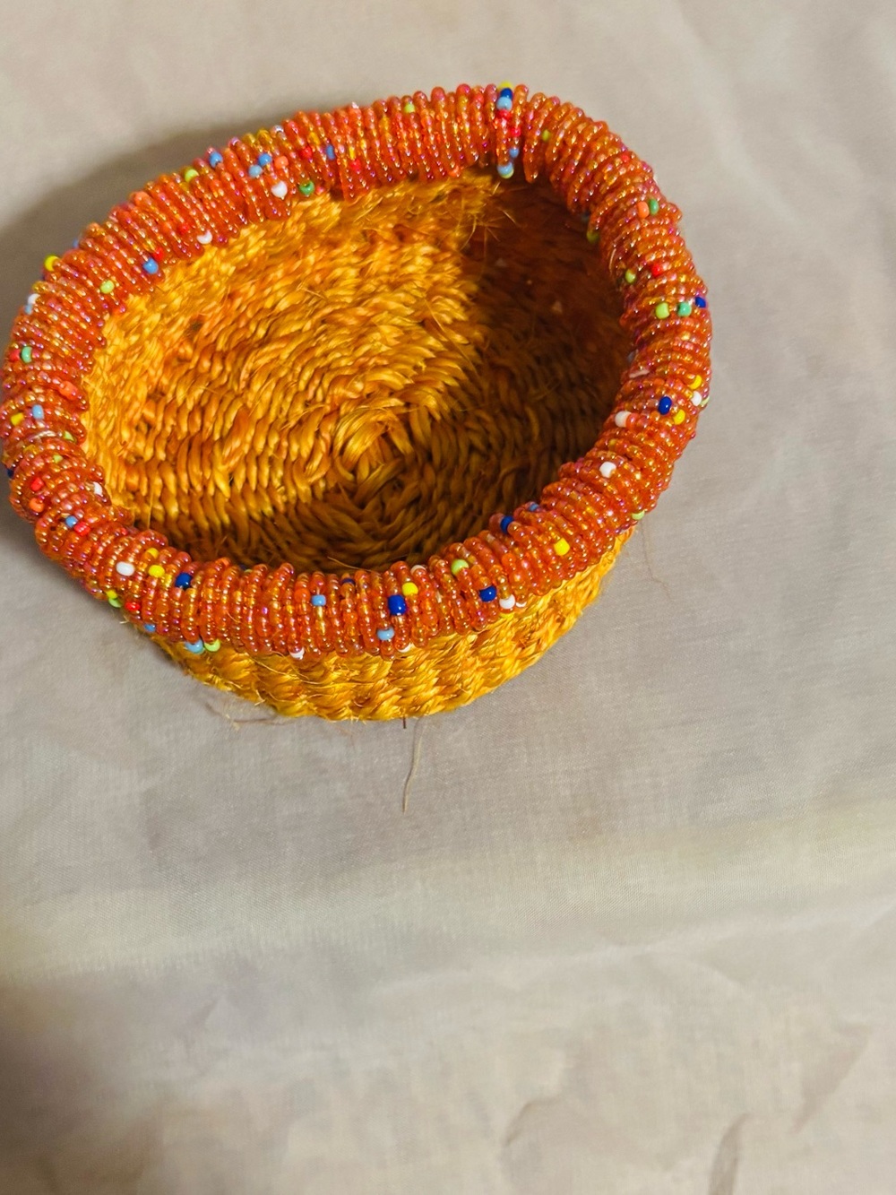 Handwoven Orange Jewelry Basket with Beaded Accent